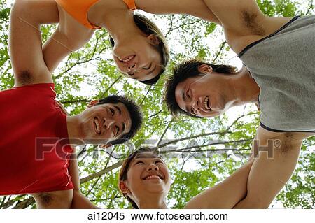Two women and two men, arms around each other View Large Photo Image Stock Photography - Two women and two men, arms around each other. Fotosearch
