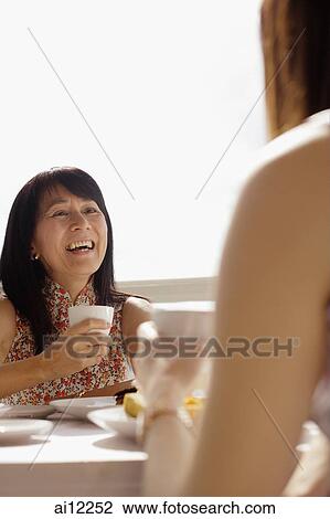 Two women having tea View Large Photo Image Stock Image - Two women having tea. Fotosearch