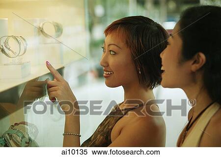Two women in front of shop window, View Large Photo Image Stock Photography - Two women in front of shop window,. Fotosearch