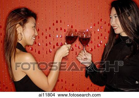 Two women, toasting with wine glasses View Large Photo Image Picture - Two women, toasting with wine glasses. Fotosearch