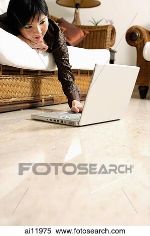 Woman at home, using laptop View Large Photo Image Stock Photography - Woman at home, using laptop. Fotosearch