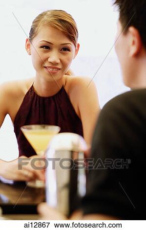 Woman facing man, drink in front of her View Large Photo Image Stock Photo - Woman facing man, drink in front of her. Fotosearch