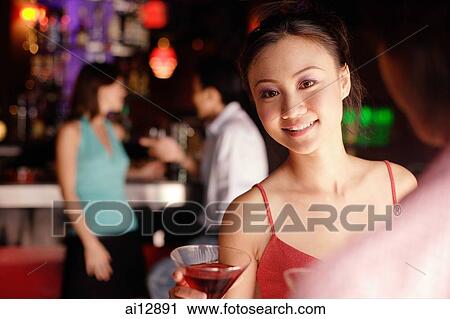 Stock Image - Woman facing man, looking over shoulder at camera. Fotosearch
