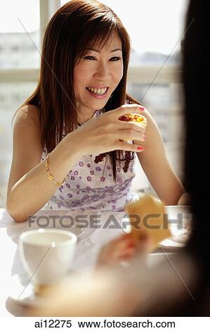 Woman holding cake slice, facing another woman View Large Photo Image Stock Photography - Woman holding cake slice, facing another woman. Fotosearch