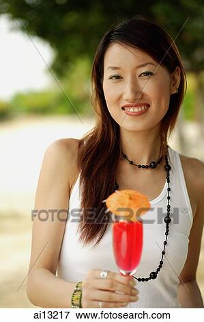 Woman holding drink View Large Photo Image Stock Photo - Woman holding drink. Fotosearch