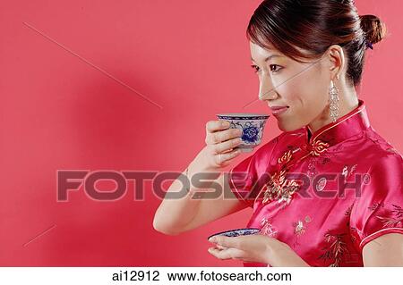 Woman holding teacup, drinking, sideview View Large Photo Image Stock Image - Woman holding teacup, drinking, sideview. Fotosearch