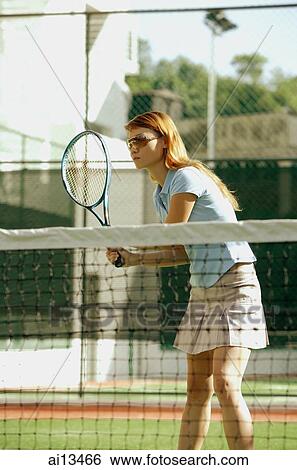 Woman holding tennis racket, playing tennis View Large Photo Image Stock Photograph - Woman holding tennis racket, playing tennis. Fotosearch