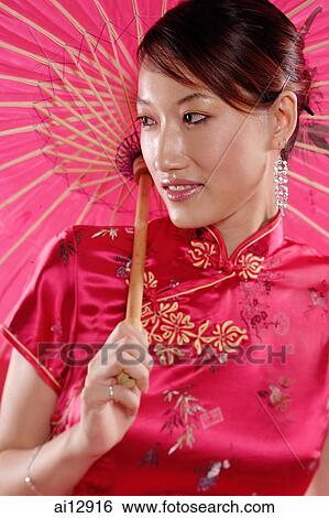 Woman holding umbrella, looking away View Large Photo Image Stock Photograph - Woman holding umbrella, looking away. Fotosearch