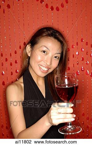 Woman holding wine glass, smiling View Large Photo Image Stock Image - Woman holding wine glass, smiling. Fotosearch