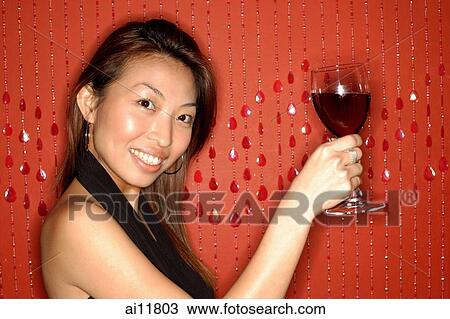Woman holding wine glass, smiling View Large Photo Image Stock Image - Woman holding wine glass, smiling. Fotosearch