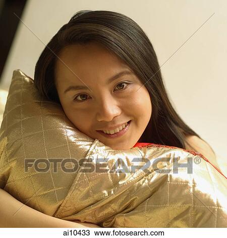 Woman hugging pillow, looking at camera View Large Photo Image Stock Image - Woman hugging pillow, looking at camera. Fotosearch
