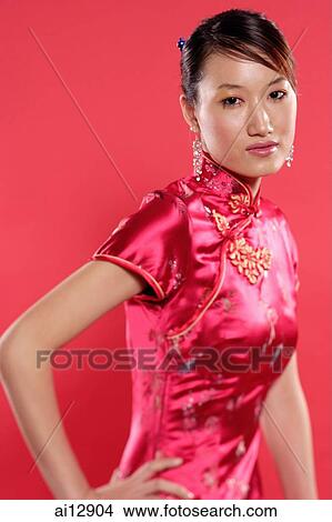 Woman in Cheongsam, hand on hip, looking at camera View Large Photo Image Picture - Woman in Cheongsam, hand on hip, looking at camera. Fotosearch