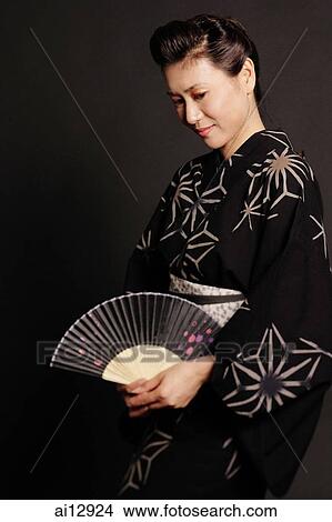 Woman in Japanese costume, holding fan View Large Photo Image Picture - Woman in Japanese costume, holding fan. Fotosearch