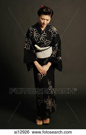 Woman in Japanese costume, standing, hands clasped View Large Photo Image Stock Photograph - Woman in Japanese costume, standing, hands clasped. Fotosearch