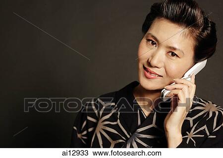 Woman in Japanese costume, using mobile phone View Large Photo Image Stock Image - Woman in Japanese costume, using mobile phone. Fotosearch