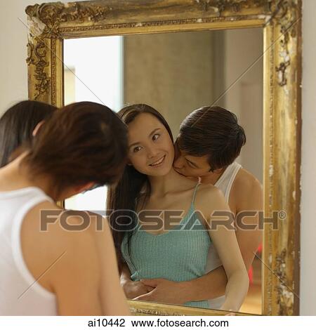 Woman looking at mirror, man kissing her neck View Large Photo Image Stock Image - Woman looking at mirror, man kissing her neck. Fotosearch