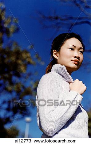 Woman looking away, low angle view View Large Photo Image Stock Image - Woman looking away, low angle view. Fotosearch