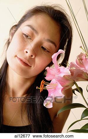 Woman next to flowers, looking away View Large Photo Image Stock Photo - Woman next to flowers, looking away. Fotosearch