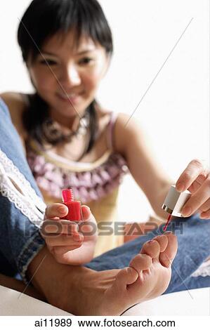 Woman painting her toenails View Large Photo Image Stock Photo - Woman painting her toenails. Fotosearch