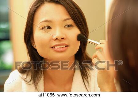 Woman putting on make-up with a blush brush View Large Photo Image Stock Photography - Woman putting on make-up with a blush brush. Fotosearch