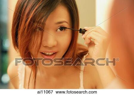 Woman putting on mascara. View Large Photo Image Stock Photo - Woman putting on mascara.. Fotosearch