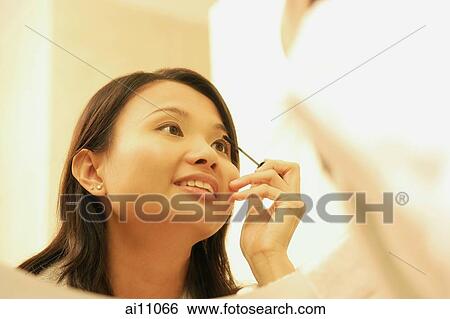 Woman putting on mascara. View Large Photo Image Stock Photograph - Woman putting on mascara.. Fotosearch