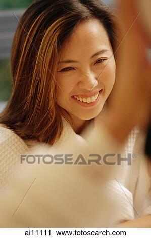 Woman smiling, focus on the background View Large Photo Image Stock Image - Woman smiling, focus on the background. Fotosearch