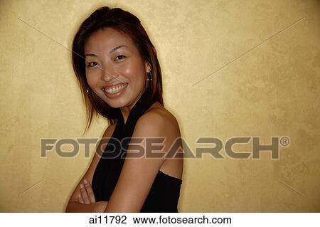 Woman standing, arms crossed, looking at camera View Large Photo Image Stock Image - Woman standing, arms crossed, looking at camera. Fotosearch