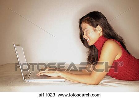 Woman using laptop, profile View Large Photo Image Stock Image - Woman using laptop, profile. Fotosearch