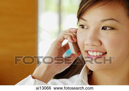 Woman using mobile phone, looking away View Large Photo Image Stock Photograph - Woman using mobile phone, looking away. Fotosearch