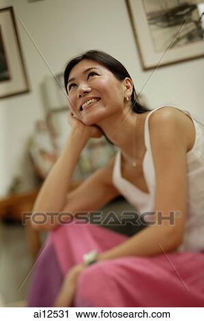 Woman with hand on chin, looking up View Large Photo Image Stock Image - Woman with hand on chin, looking up. Fotosearch