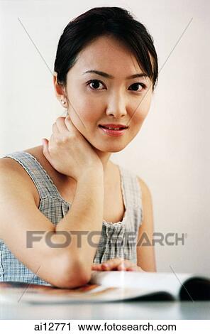 Woman with hand under chin, looking at camera View Large Photo Image Stock Image - Woman with hand under chin, looking at camera. Fotosearch