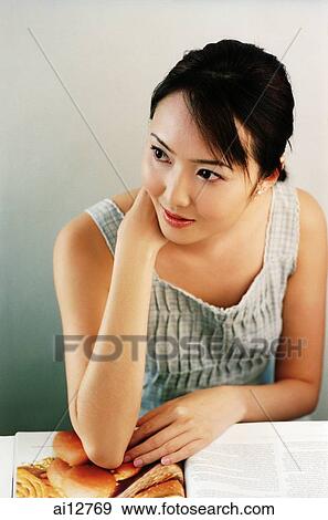 Woman with hand under chin, looking away View Large Photo Image Stock Photo - Woman with hand under chin, looking away. Fotosearch