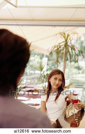 Woman with wine glass, looking at man. View Large Photo Image Stock Photograph - Woman with wine glass, looking at man.. Fotosearch