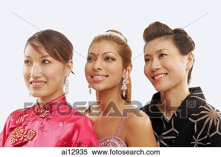 Stock Photography - Women in traditional costumes, looking away, head shot. Fotosearch