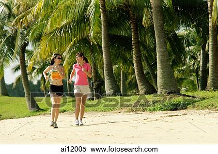 Women jogging along beach View Large Photo Image Stock Photography - Women jogging along beach. Fotosearch