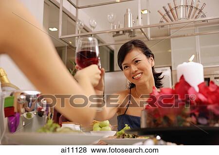 Women raising wine glass, toasting View Large Photo Image Stock Photo - Women raising wine glass, toasting. Fotosearch