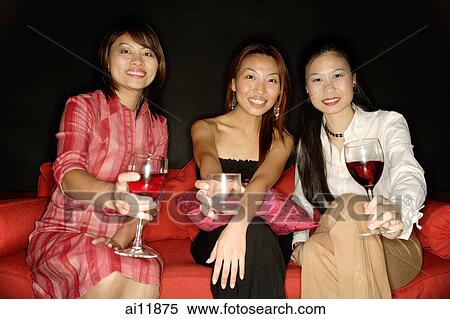 Stock Photography - Women with drinks, looking at camera. Fotosearch