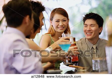 Young adults at bar counter, with drinks View Large Photo Image Stock Photo - Young adults at bar counter, with drinks. Fotosearch