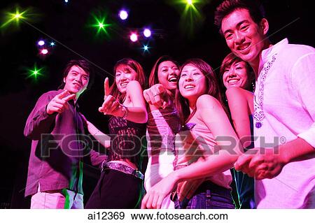 Young adults at night club, dancing in a row View Large Photo Image Stock Photo - Young adults at night club, dancing in a row. Fotosearch