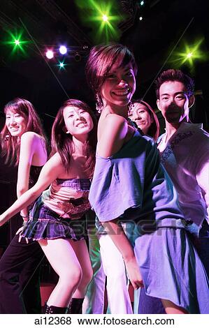 Young adults at night club, dancing View Large Photo Image Stock Photo - Young adults at night club, dancing. Fotosearch