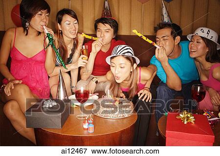 Young adults celebrating with noisemakers and party hats View Large Photo Image Stock Photo - Young adults celebrating with noisemakers and party hats. Fotosearch