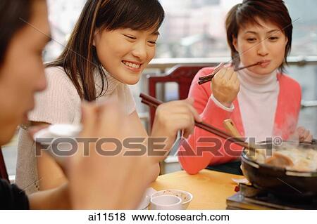 Young adults eating at a restaurant View Large Photo Image Stock Photo - Young adults eating at a restaurant. Fotosearch
