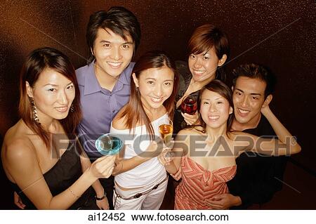 Young adults holding drinks, looking up at camera View Large Photo Image Stock Image - Young adults holding drinks, looking up at camera. Fotosearch