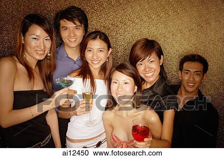 Young adults holding drinks, smiling and looking at camera View Large Photo Image Stock Image - Young adults holding drinks, smiling and looking at camera. Fotosearch