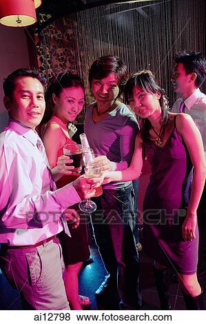 Young adults in club, looking at camera, holding drinks View Large Photo Image Stock Photo - Young adults in club, looking at camera, holding drinks. Fotosearch