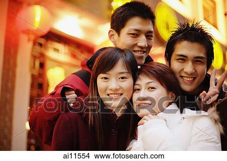 Young adults looking at camera, smiling View Large Photo Image Picture - Young adults looking at camera, smiling. Fotosearch