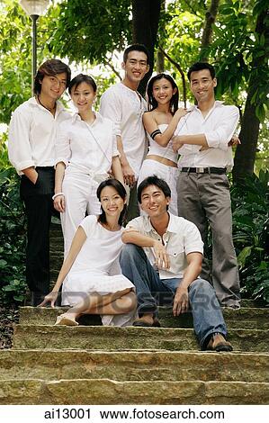 Stock Image - Young adults looking at camera. Fotosearch