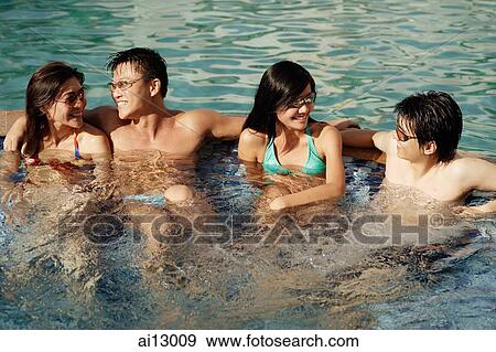 Young adults lounging in pool View Large Photo Image Stock Photo - Young adults lounging in pool. Fotosearch