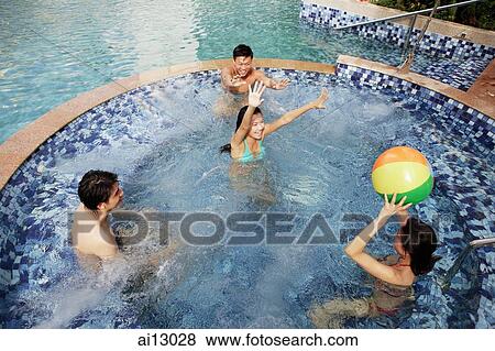 Young adults playing with inflatable ball in swimming pool, high angle view View Large Photo Image Stock Photo - Young adults playing with inflatable ball in swimming pool, high angle view. Fotosearch